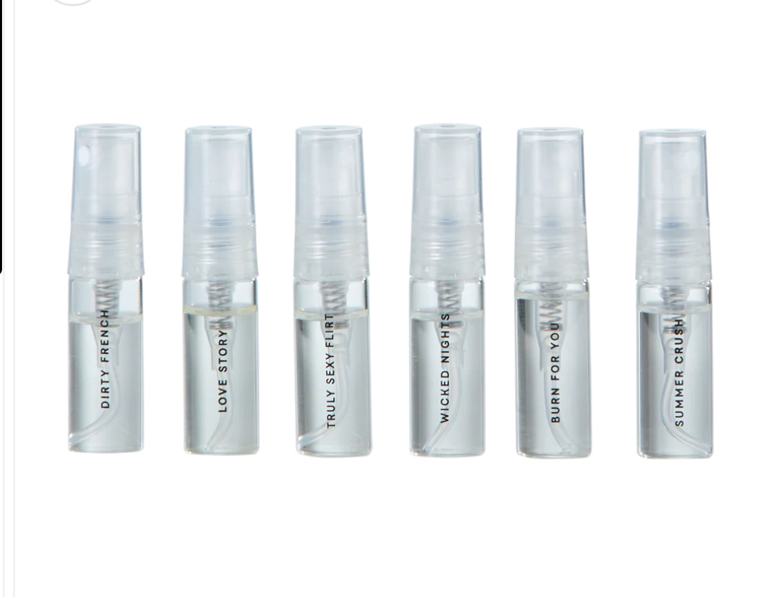 Six clear fragrance sample spray bottles labeled Dirty French, Love Story, Truly Sexy Flirt, Wicked Nights, Burn For You, and Summer Crush on a white background.