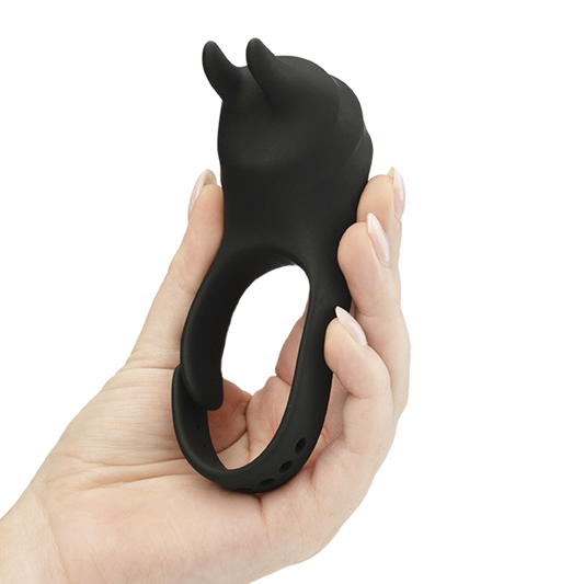 Hand holding a black silicone vibrating ring with bunny ear tips, adult wellness product