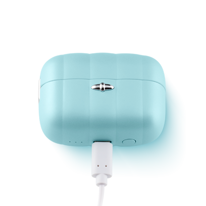Blue ergonomic personal massager charging with white USB cable on white background