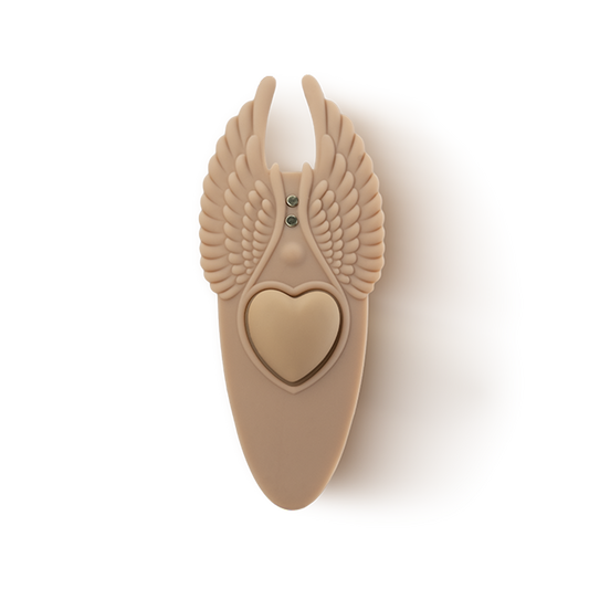 Beige silicone massage accessory with heart center and wing design, wellness product