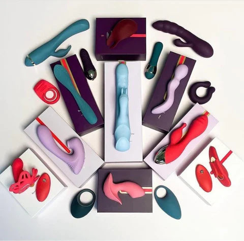 Assorted colorful personal massagers and wellness devices arranged on boxes