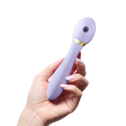 Hand holding a purple silicone personal massager with gold accent, wellness product