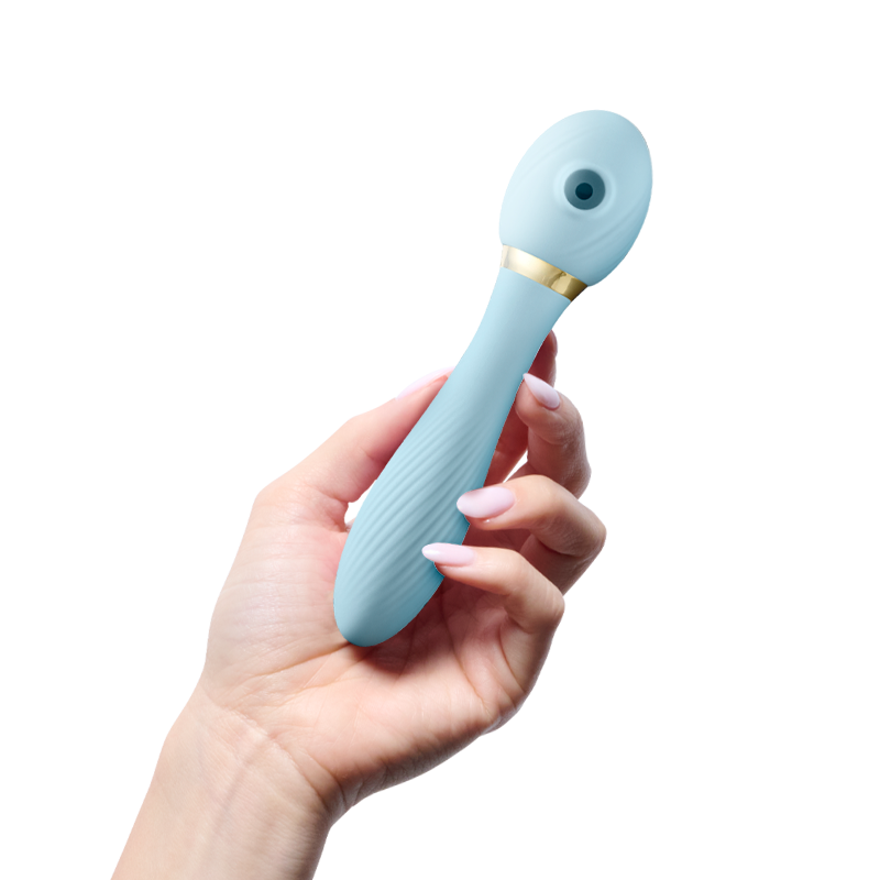 Hand holding blue silicone personal massager with gold accent on white background
