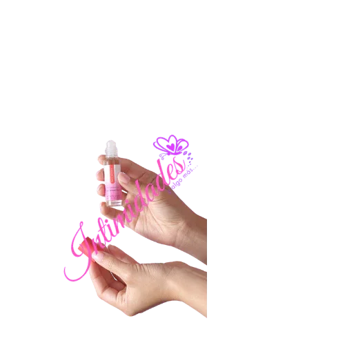 Hands holding a small clear skin care serum bottle with pink label, wellness product