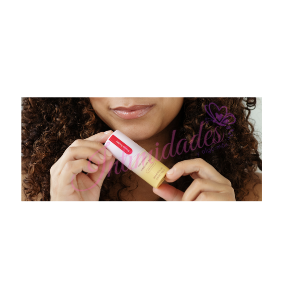 Woman holding hydrating lip balm, close-up on lips and skincare product.