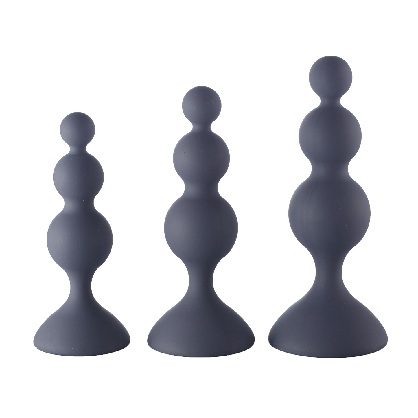 Set of three graduated black silicone beaded trainer plugs on a neutral background.