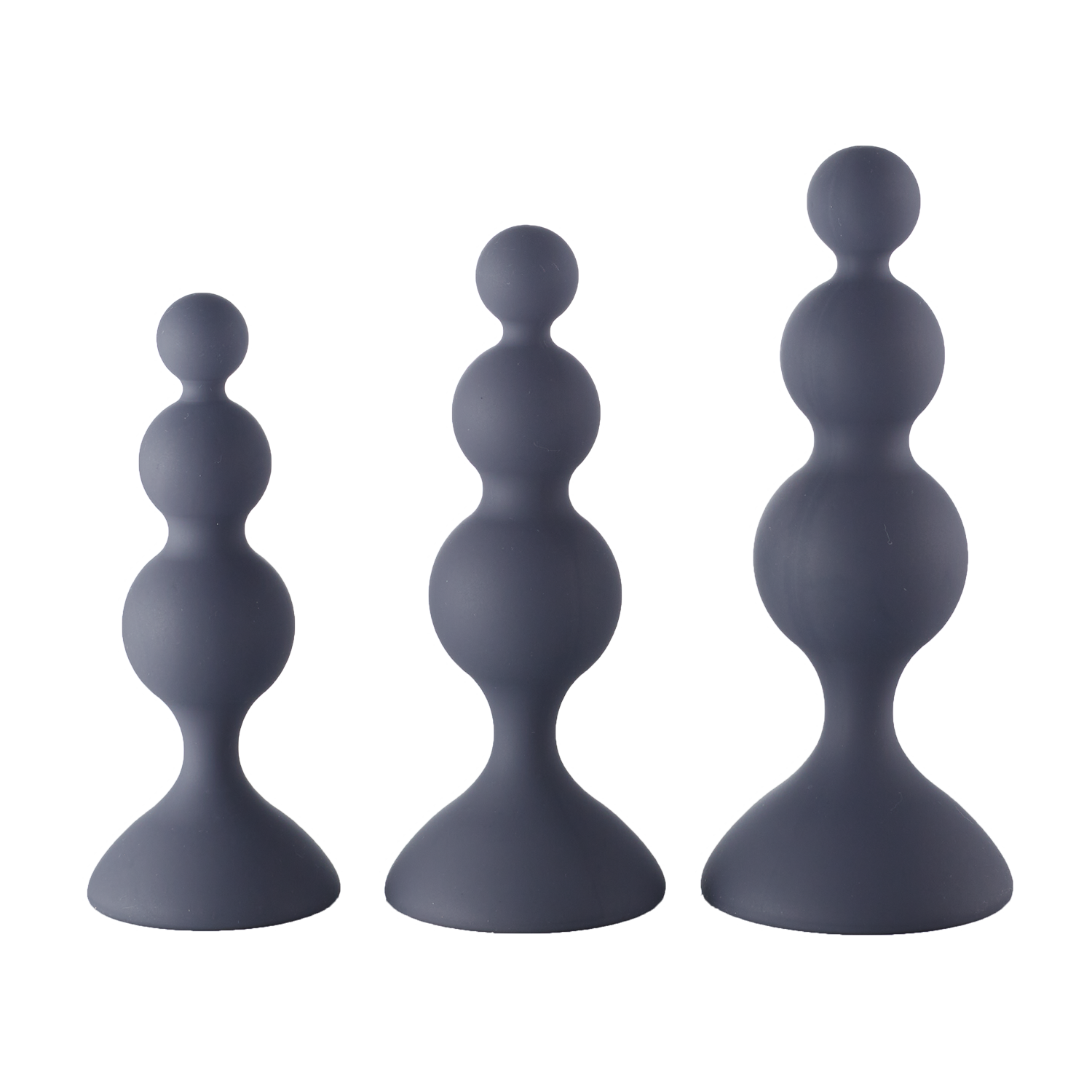 Set of three graduated black silicone beaded trainer plugs on a neutral background.