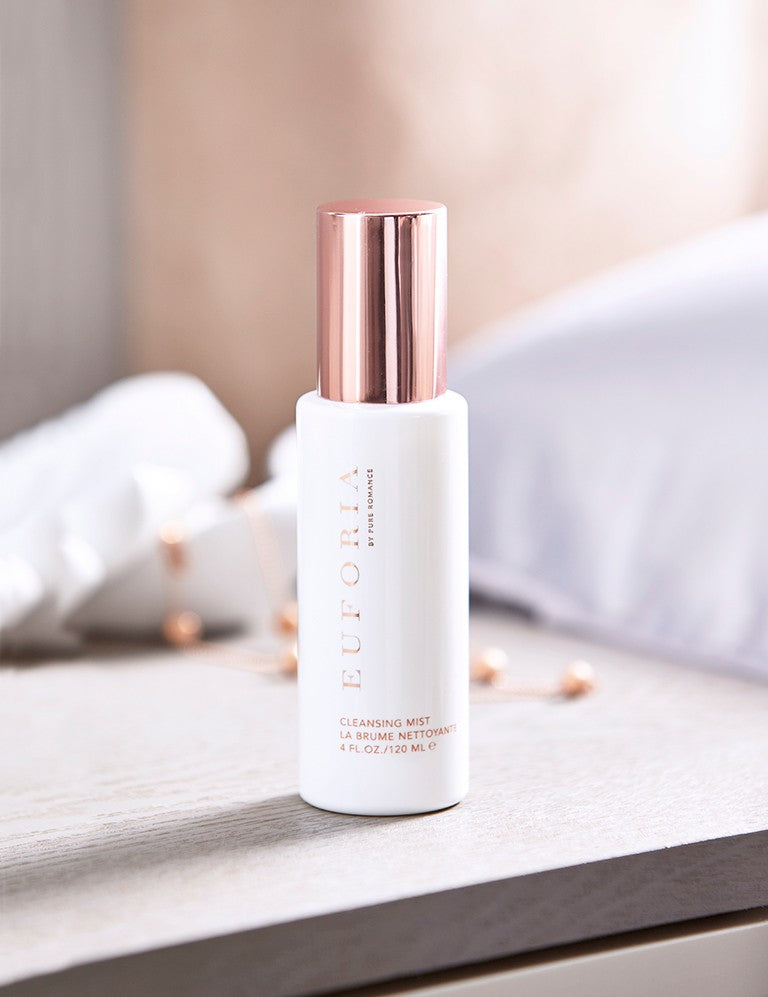 Euforia Cleansing Mist skincare spray with rose gold cap on wooden surface, wellness background