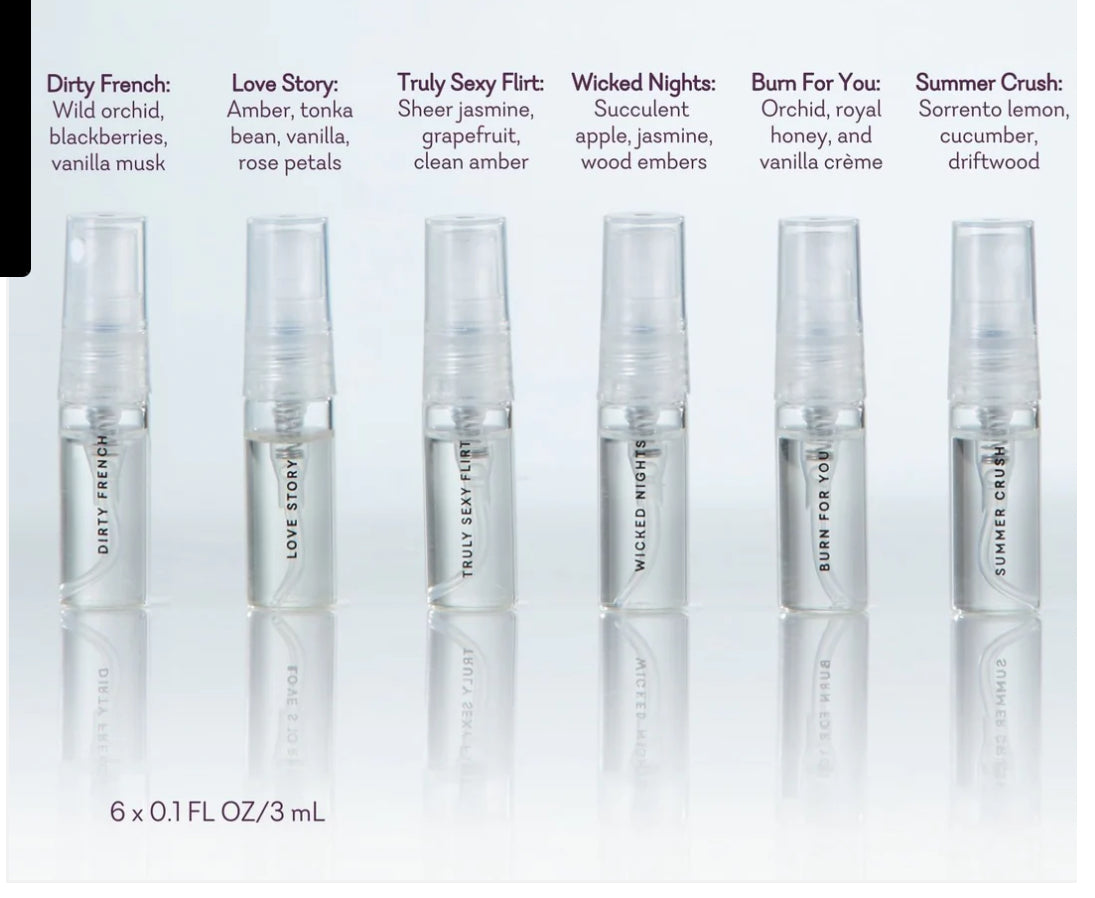 Set of six clear perfume sample sprays with scent names and notes, arranged in a row on a white background.