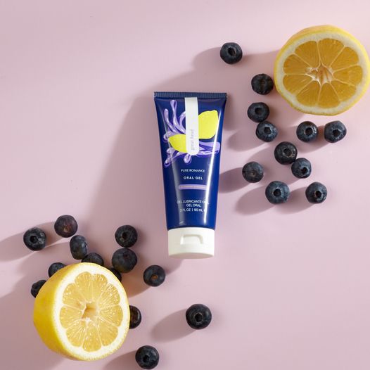 Tube of gel with blueberry and lemon design, surrounded by fresh blueberries and lemons on pink background