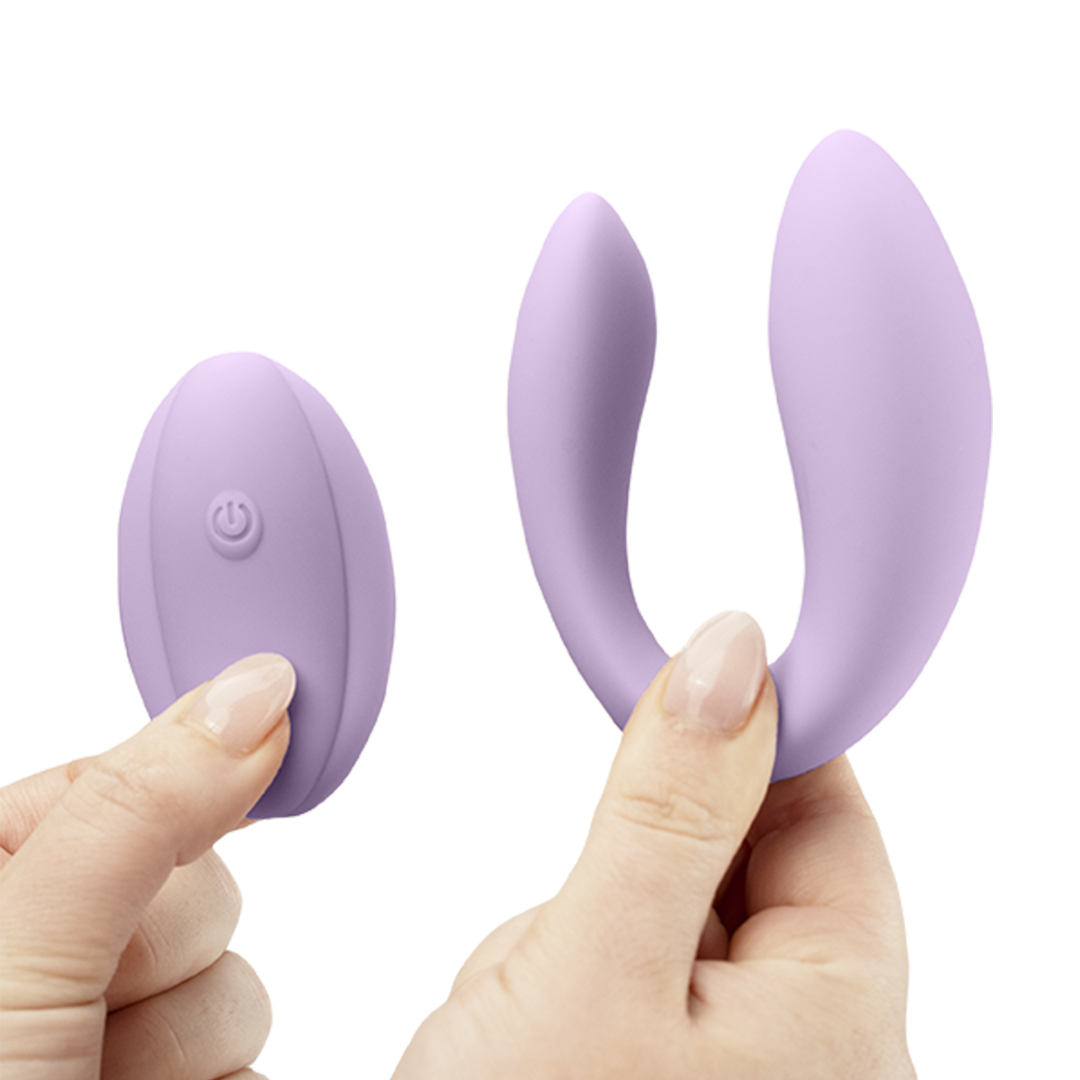 Purple silicone wearable couples vibrator with remote control held in hands