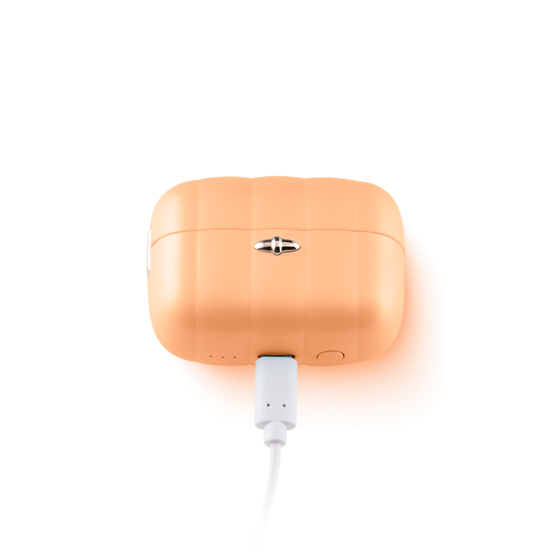 Orange silicone personal massager charging in case, wellness and self-care product