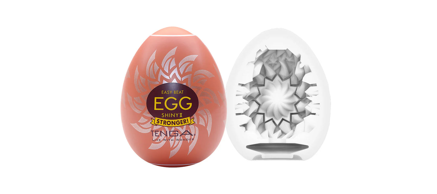Textured egg-shaped male wellness product with decorative pattern and internal structure
