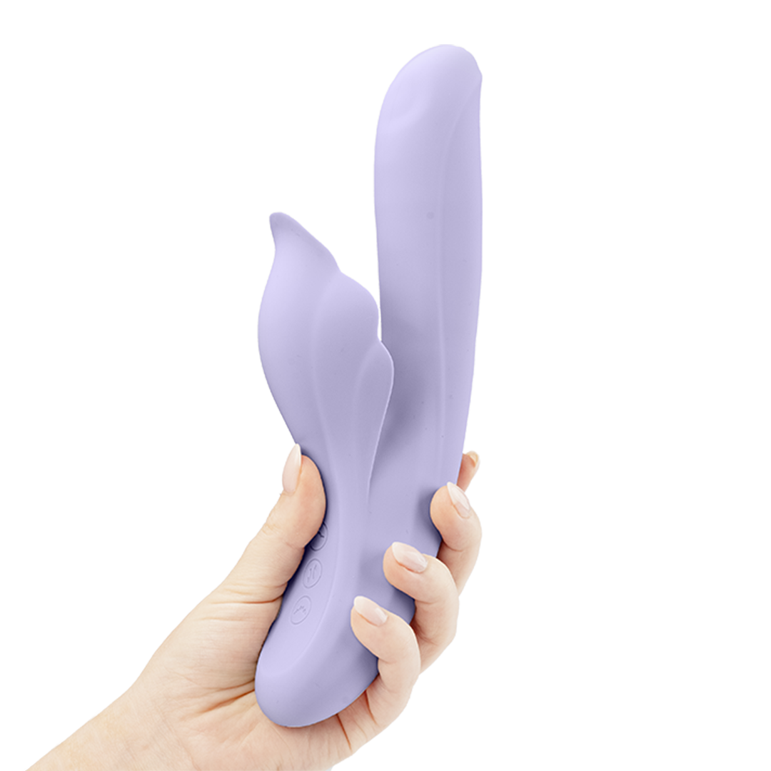 Hand holding a lavender dual-action silicone vibrator with ergonomic design
