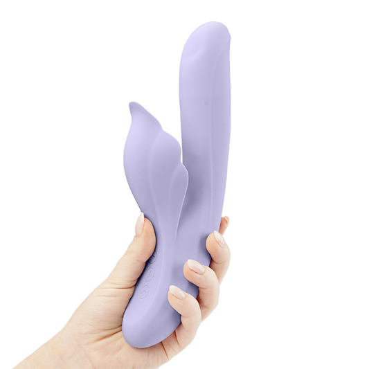 Hand holding a lavender dual-action silicone vibrator with ergonomic design