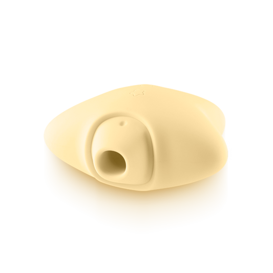 Beige silicone wellness device with a round opening, smooth surface, and ergonomic shape
