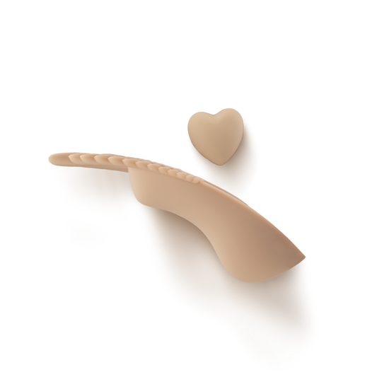 Beige silicone intimate wellness massager with curved shape and heart-shaped tip