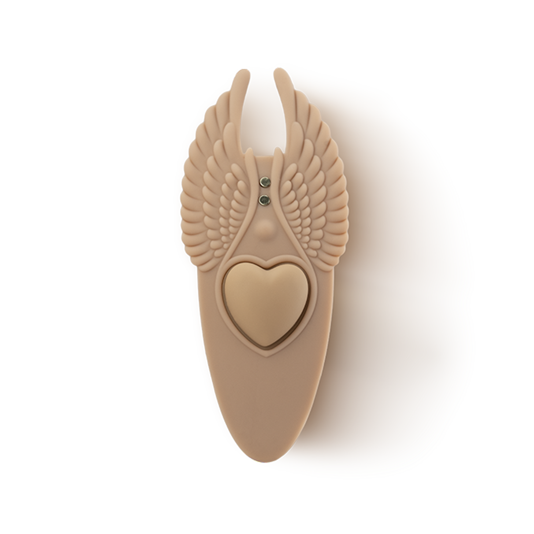 Beige silicone massage accessory with heart center and wing design, wellness product