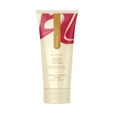 Whipped strawberry cheesecake body cream in beige and pink tube on white background