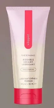 Tube of vanilla kissable creamy lubricant with pink accents on a neutral background