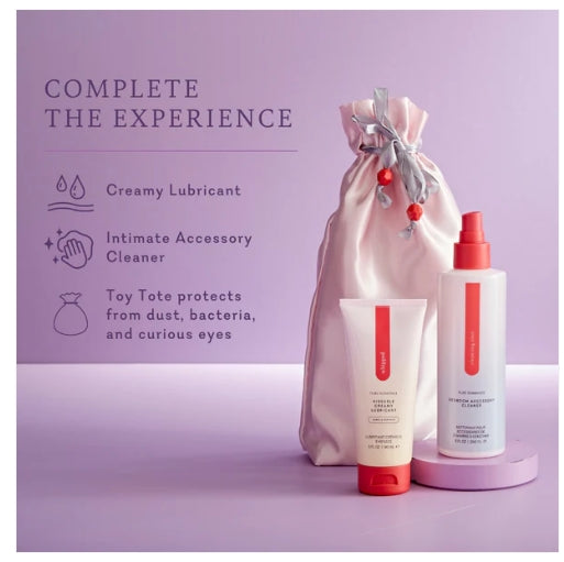 Creamy lubricant, intimate accessory cleaner, and storage bag set on a purple background.