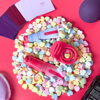 Romantic wellness products and massage creams on pastel heart candies, vibrant background