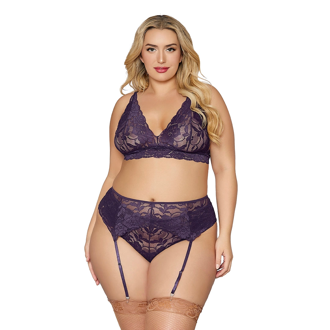 Plus size woman modeling purple lace bralette, high-waisted panties, and garter belt
