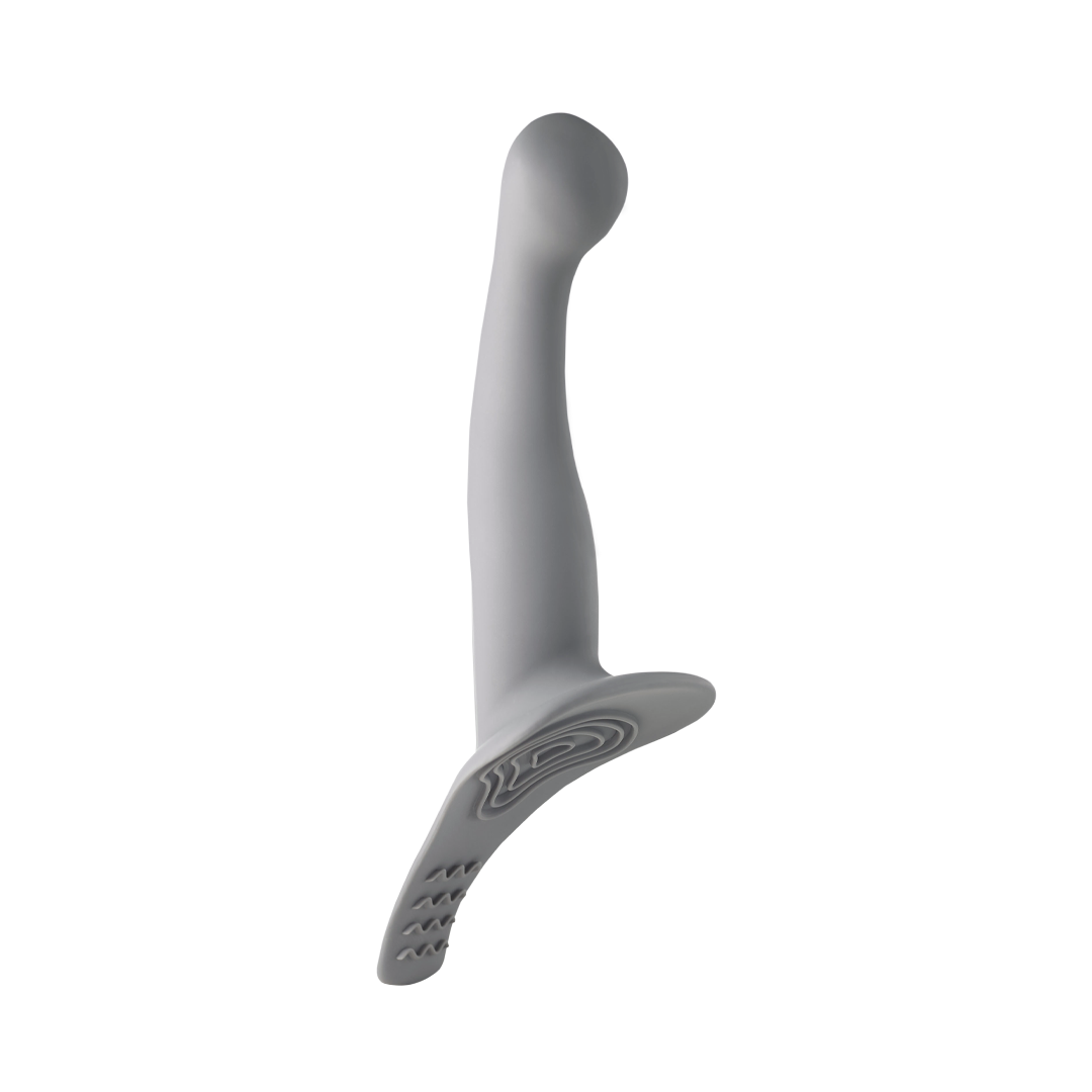 Gray silicone vibrating strap-on attachment with curved ergonomic design on white background