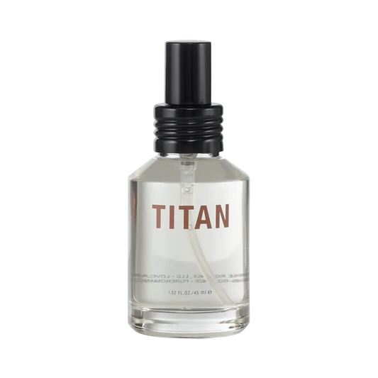 Clear glass bottle labeled TITAN with black spray cap, personal wellness product